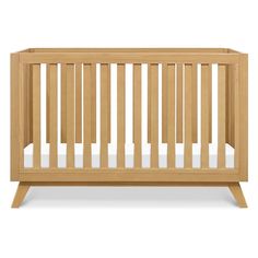 a wooden crib with white sheets on the bottom and side rails, against a white background