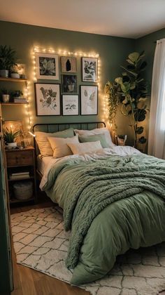 a bedroom decorated in green and white with string lights on the wall above the bed