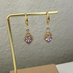 Pretty princess style earrings  Available in purple or pink  Material is gold plated copper The purple style has a matching necklace in this link: https://www.etsy.com/listing/1233265316/handmade-purple-princess-regency Elegant Purple Cubic Zirconia Crystal Earrings, Elegant Purple Earrings As A Gift For Her, Elegant Purple Drop Crystal Earrings, Elegant Purple Earrings For Her, Elegant Purple Crystal Earrings, Elegant Purple Jewelry With Ear Wire, Elegant Purple Crystal Pierced Earrings, Elegant Purple Gold-plated Jewelry, Disney Princess Earrings