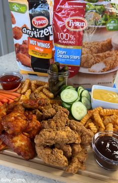 chicken wings, carrots, celery, cucumbers and other ingredients on a cutting board