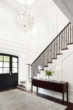 the inside of a house with stairs and chandelier above it is instagramted