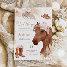 a birthday card with a horse wearing cowboy boots and flowers on it, sitting next to some flowers