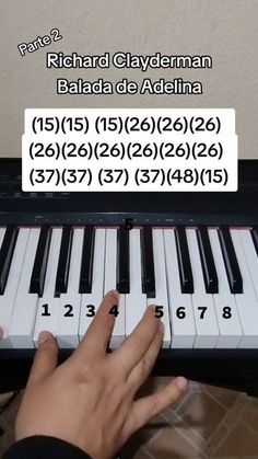 a person is playing the piano with their hands and numbers on it's keyboard