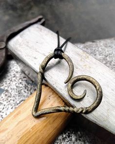 an old pair of scissors sitting on top of a piece of wood next to a hammer