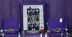 purple and white altars with silver decorations on the front, sitting against a purple backdrop