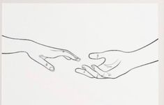 two hands reaching for each other over a piece of paper that has been drawn on it