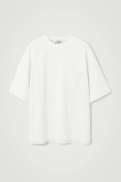 The Heavy Duty T-shirt is a few steps up from your classic jersey tee. Weighing in at a substantial 290gsm, it's made with premium organic cotton that's hefty, warm and holds the boxy shape in place. It's designed with a mock neck, dropped shoulders and a casual patch pocket at the chest – perfect for hooking your sunglasses onto. Oversized fit, 290gsmSide slits, stepped hemOrganic cotton is grown from non-genetically modified seeds without chemical fertilisers or pesticides Shell: 70% Organic cotton, 30% Viscose. Excluding trims / Machine wash Back length of size M is 73cm / Model wears a size M White Boxy Classic T-shirt, Mock Up T Shirt, Belted Cape, Perspective Sketch, White Tee Shirts, Plain Shirt, Genetically Modified, Modern Wardrobe, Cashmere Coat