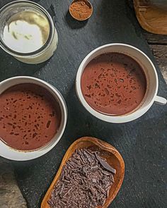 three bowls filled with different types of chocolate