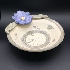 a ceramic bowl with a flower on it