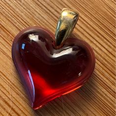 a heart shaped object sitting on top of a wooden table