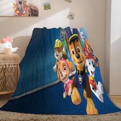 there is a blanket with the characters of paw patrol on it in this living room