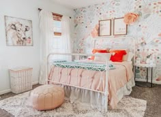 a bed room with a neatly made bed and pictures on the wall