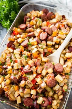 a casserole dish filled with potatoes and sausage