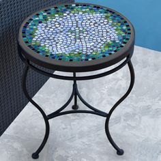 a small table with a mosaic design on it