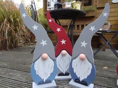 two gnomes with red, white and blue stars on their heads