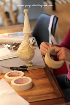 a woman sitting at a table with some food on top of it and an onion in front of her