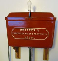 a red metal box with a light bulb on it's side and a sign that says crapper's