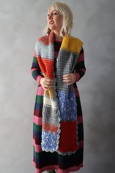 a woman wearing a multicolored knitted scarf