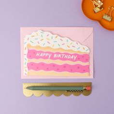 a birthday card with a pink frosted cake and sprinkles on it