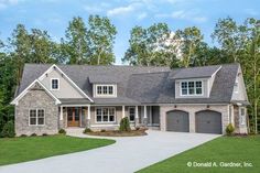 a large house with two garages and lots of windows