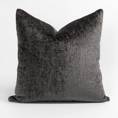 a black and grey pillow on a white background