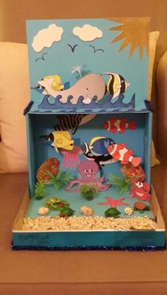 an ocean scene made out of cardboard with sea animals and fish on the bottom shelf