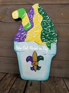 a painted ice cream sundae sitting on top of a wooden table