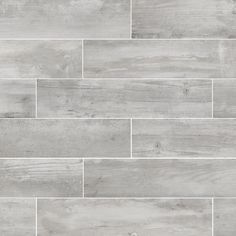 a white tile wall with grey wood planks on it's sides and the floor