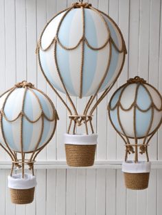 three blue and white hot air balloons hanging from ropes