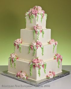 a three tiered cake with pink flowers on it