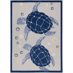 a blue and white rug with two sea turtles on the front, one turtle in the middle