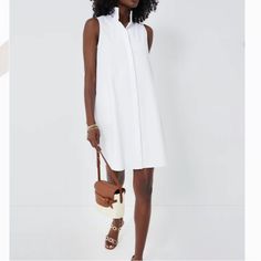 The Sleeveless Charlie Dress Is A Customer Favorite And Refreshed For Warm-Weather. This Classic White Mini Will Take You From Day To Night With The Quick Switch Of Shoes. We Love Pairing This With A Denim Jacket And Sneakers For A Sporty Look Or Espadrilles And Statement Earrings For Dinner Al Fresco! Stand Collar Sleeveless Button Front Placket Side Seam Pockets Mini Length Full A-Line Silhouette Material: 58% Cotton, 40% Nylon, 2% Spandex Care: Dry Clean Only Xxs Pit To Pit 18” Xs Pit To Pit White Sleeveless Shirt Dress For Beach, White Sleeveless Day Dress, White Sleeveless Daywear Dress, White Sleeveless Shirt Dress For Daywear, Sleeveless Shirt Dress For Summer Daywear, White Sleeveless Shirt Dress For Work, Sleeveless White Shirt Dress For Work, White Sleeveless Maxi Dress For Daywear, White Sleeveless Dress For Daywear