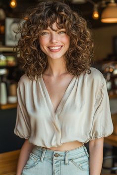 Discover how to elevate your style with this stunning curly hairstyle featuring soft bangs. This look beautifully frames your face while the bouncy curls add volume and movement. Perfect for any occasion, this hairstyle radiates fun and flirtation. Whether you're heading to brunch or a night out, it’s a versatile look that highlights your features. Embrace the charm of curly hairstyles combined with bangs! #curlyhairstyles Medium Curly Bangs, Curly Hairstyle Round Face, Curly Bangs For Round Face, Hairstyles With Bangs Curly Hair, Curly Hair Models, Curly French Bangs, Curly French Hair, Curly Hair Butterfly Haircut