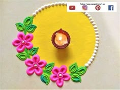 a small cupcake decorated with flowers on a yellow plate and white bead border