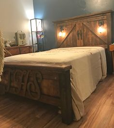 a bed sitting on top of a hard wood floor next to a wooden headboard