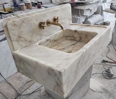 a marble sink sitting in the middle of a room