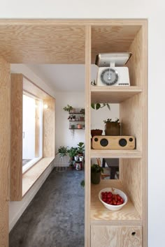 a room with shelves filled with plants and fruit