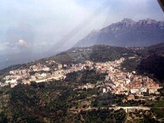 an aerial view of a city with mountains in the background