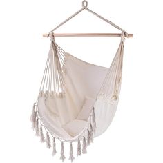 a white hanging hammock with tassels on the bottom and one side