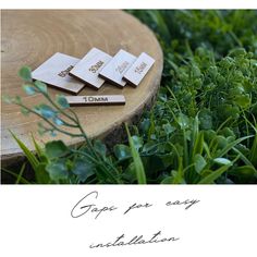 four wooden tags sitting on top of green grass