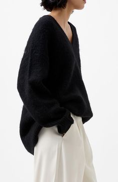 Fluffy, alpaca-kissed yarn comprises a V-neck sweater knit in an on-trend oversize profile. V-neck Long sleeves Ribbed cuffs and hem 46% acrylic, 20% polyester, 20% polyamide, 6% alpaca, 6% wool, 2% elastane Machine wash, line dry Imported Black Oversized Sweater Outfit, Black V Neck Sweater Outfit, Fluffy Alpaca, Oversized Black Sweater, Black V Neck Sweater, Black Knit Sweater, Favorite Daughter, Wardrobe Ideas, Blazer With Jeans