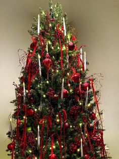 a decorated christmas tree with candles and ornaments