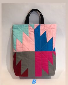 "This is a quilted tote bag handmade with delectable mountain quilt block patchwork. Classic pattern with modern color block placement. Well made and very stylish. It is roomy enough as a day bag. Perfect gift for anybody. All 100% cotton fabrics. Exterior pieces are quilted with 100% natural cotton batting. Lining is a 100% natural duck cotton fabric. Handles are black heavy duty cotton canvas webbing straps. It has inner pocket, big enough for phone or sunglasses and genuine black leather stri Square Cotton Patchwork Bag, Multicolor Quilted Bags, Everyday Multicolor Quilted Bags, Multicolor Quilted Tote Bag, Delectable Mountain Quilt, Mountain Quilt Block, Mountain Quilt, Mountain Quilts, Small Dog Harness