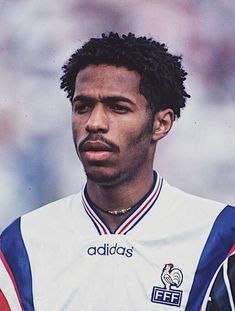 a close up of a soccer player wearing a uniform with stripes on it's chest