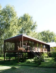 the house is surrounded by trees and grass