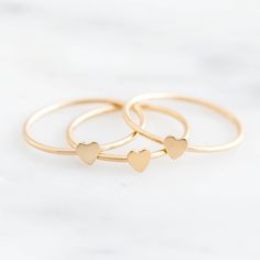 Our Heart Stacking Ring might be the sweetest stacking ring there is. You’ll never want to take this little gem off - and you won’t have to! Made of gold filled, perfect for everyday wear! Find more dainty rings & jewelry at Simple & Dainty. Cute Heart Ring For Gift, Delicate Stackable Promise Rings For Valentine's Day, Dainty Heart Charm Stackable Gift Rings, Simple Tiny Stackable Rings As Gift, Dainty Stackable Gift Rings With Heart Charm, Delicate Heart Charm Ring As Gift, Stackable Heart Midi Rings For Gift, Minimalist Rings With Heart Charm For Everyday, Stackable Heart Ring For Everyday And Valentine's Day