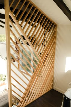 a room divider made out of wooden slats in the corner of a room