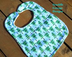 a blue bib with green trees on it