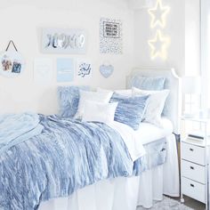 a bedroom with white walls and blue bedding