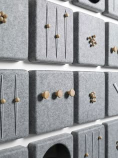 the wall is made up of gray felt and gold studs